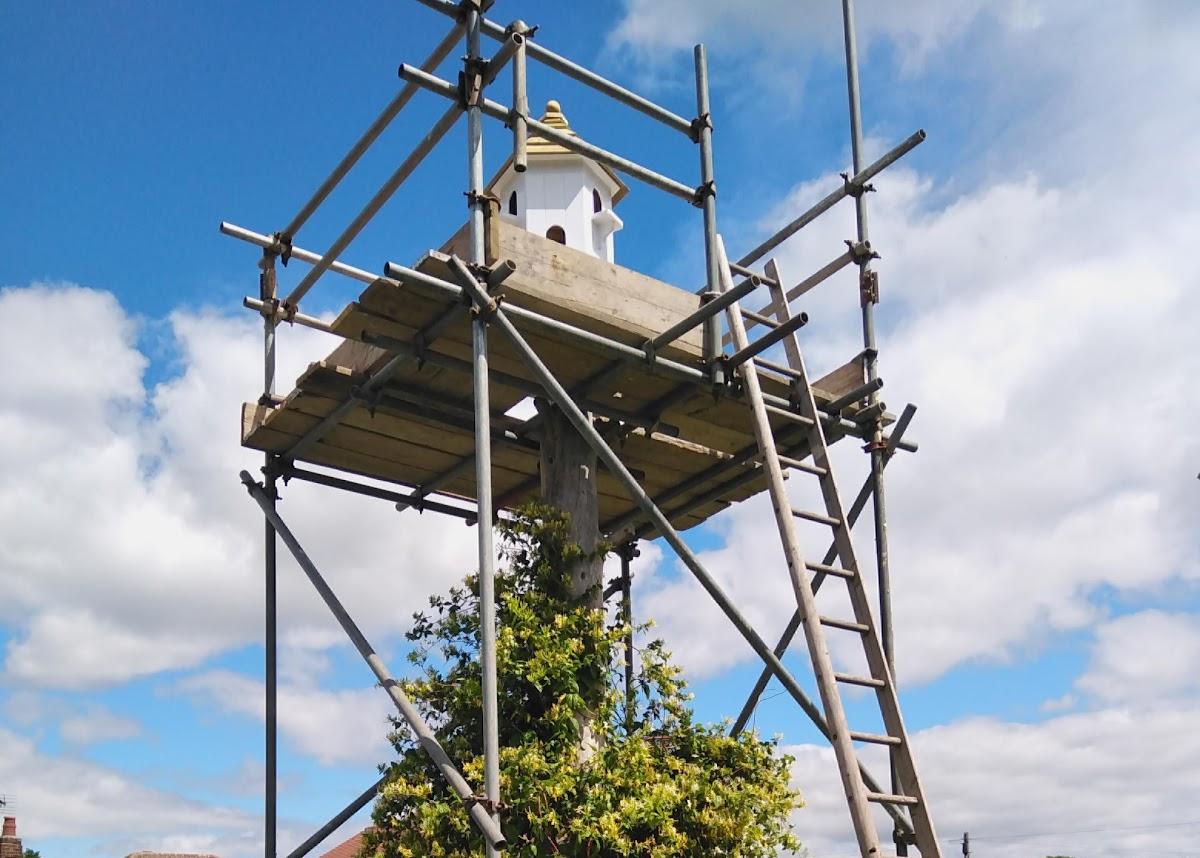 A purpose built scaffold tower erected around a garden dovecote