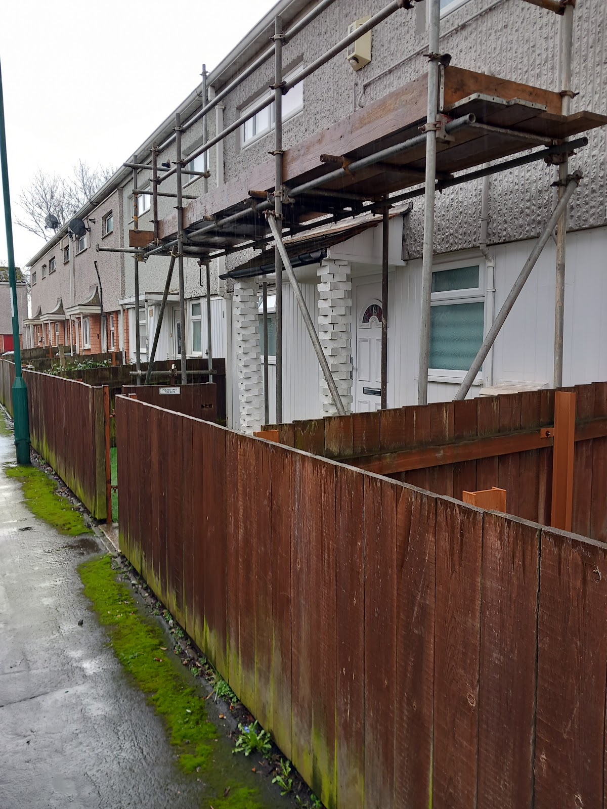 Scaffold over a front doorway on a pebbledash terrace